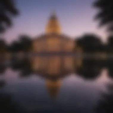 Illuminated Texas State Capitol Building reflecting in water at dusk